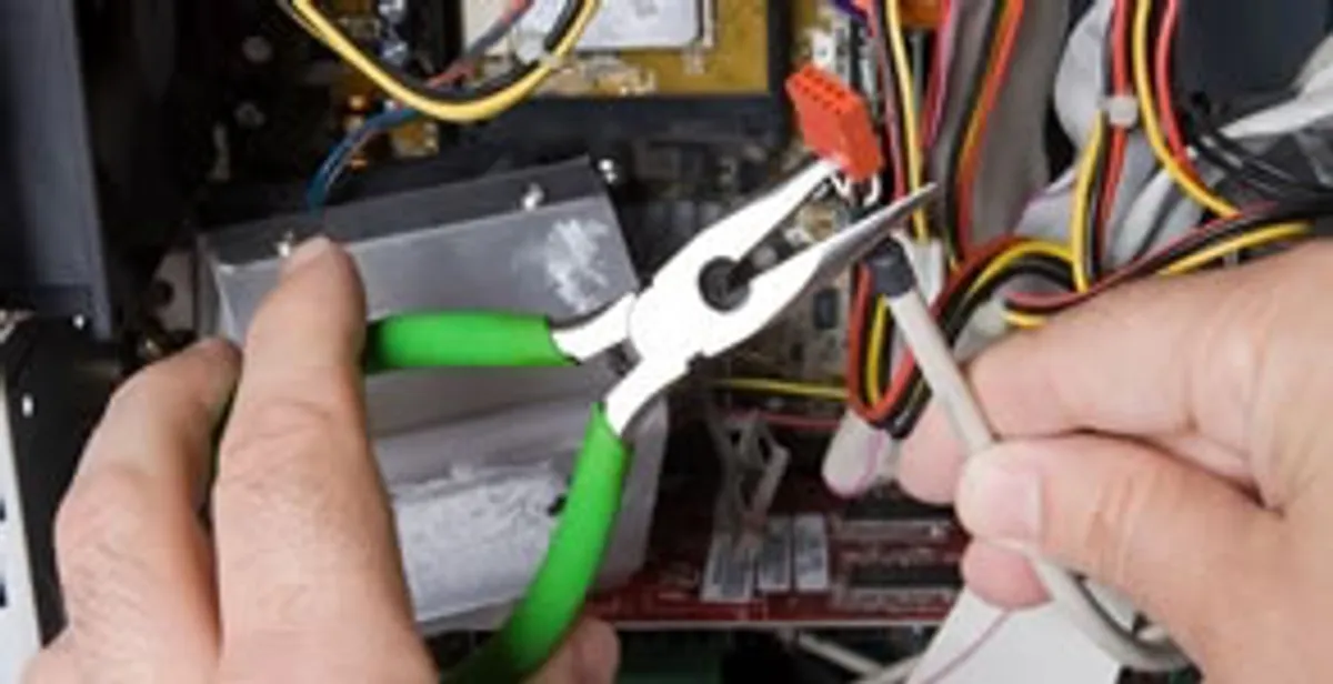 Licensed electrical contractor performing electrical repair with tools in Newcastle, OK