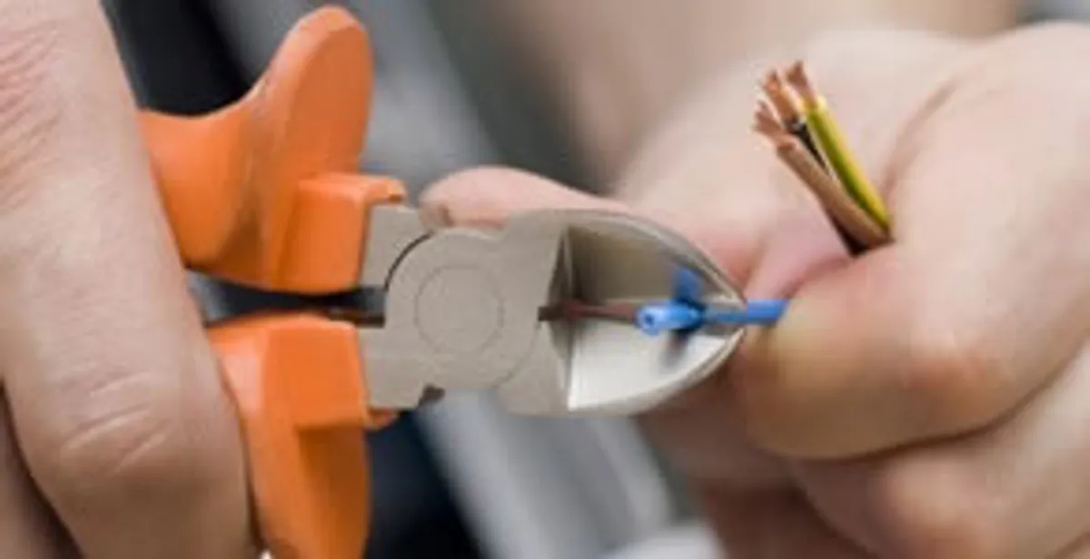 professional electrical services showing precise wire cutting by licensed electricians in Oklahoma City, OK